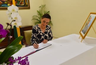 Minister of Foreign Affairs and Foreign Trade, Senator the Hon. Kamina Johnson Smith, signs the Condolence Book opened for late former State Minister, Leslie Campbell, at the Ministry’s headquarters in downtown Kingston, on Thursday (June 4). Mr. Campbell served as State Minister from 2020 to 2022. The Condolence Book, which was opened on June 3, will remain available for signing until June 5 at the Ministry, 2 Port Royal Street, between 9:00 a.m. and 4:00 p.m.
