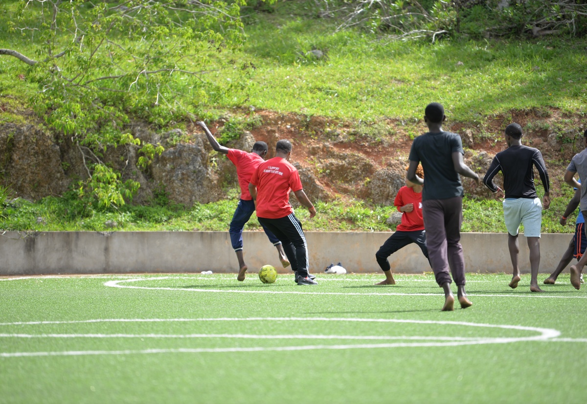 Residents of Mount Olivet Boys' Home and Jamaica Information Service (JIS) staff participate in a game of football at the annual sports day held recently at the home in Walderston, Manchester. 