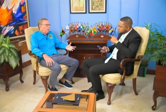 Minister of Energy, Transport and Telecommunications, Hon. Daryl Vaz (left), speaking during a Jamaica Information Service (JIS) Ministerial Update with JIS Chief Executive Officer, Giovanni Dennis, at the PCJ Building in Kingston on Thursday (June 11).
