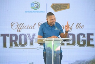 Minister without Portfolio in the Ministry of Economic Growth and Infrastructure Development, with responsibility for Works, Hon. Robert Morgan, addresses the official opening of the new $230-million Troy Bridge that connects the Troy to Oxford main road at the Manchester-Trelawny border, on June 5.
