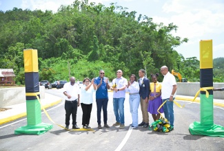 Prime Minister, Dr. the Most Hon. Andrew Holness (fourth left), cuts the ribbon to mark Friday’s (June 5) official opening of the new $230 million Troy Bridge, which connects the Troy to Oxford main road at the Manchester/Trelawny border. He is joined by (from left) Mayor of Falmouth, Councillor Collen Gager; State Minister in the Ministry of Justice and Constitutional Affairs and Member of Parliament for Trelawny Southern, Hon. Marisa Dalrymple-Philibert; Minister without Portfolio in the Ministry of Economic Growth and Infrastructure Development with responsibility for Works, Hon. Robert Morgan; Permanent Secretary in the Ministry, Arlene Williams; a student of Troy High School; and Member of Parliament for Manchester North Western, Mikael Phillips.