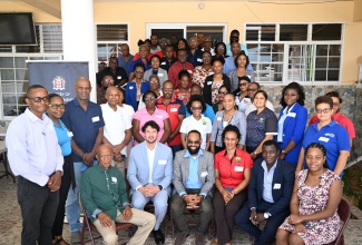 Mayor of Black River and Chairman of the St. Elizabeth Municipal Corporation, Councillor Richard Solomon (third left, seated); Senior Director for Hazard Mitigation and Risk Management in the Ministry of Local Government and Community Development, Patrick Watson (second right, seated); and Manager of Resilient Infrastructure Recovery for Local Governments at the United Nations Office for Disaster Risk Reduction (UNDRR), Christopher Lopez Maciel (second left, seated), join representatives from government agencies, emergency services, and community groups during Wednesday