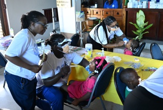 Volunteer dentists and dental students provide oral health assessments and dental care to students during the Jamaica Nurses