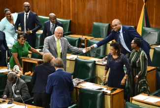 Minister of Justice and Constitutional Affairs, Hon. Delroy Chuck (centre), is congratulated by government colleagues after concluding
his contribution to the 2026/27 Sectoral Debate in the House of Representatives on June 10.