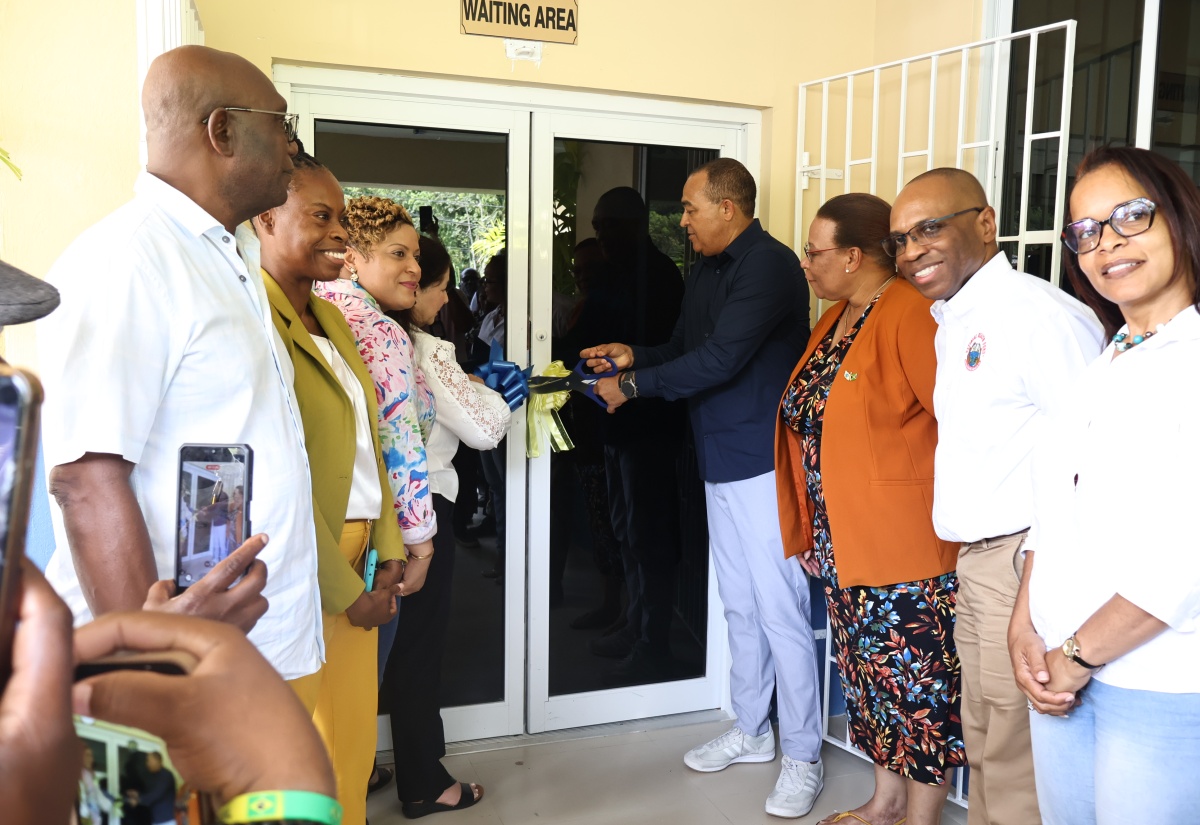 Minister of Health and Wellness, Dr. the Hon. Christopher Tufton (fourth right), and North East Regional Health Authority (NERHA) Board Chair, Laura Heron (fourth left), lead the ribbon-cutting ceremony for the rehabilitated Bamboo Community Health Centre in St. Ann on June 5, marking its official reopening and handover.
