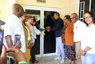 Minister of Health and Wellness, Dr. the Hon. Christopher Tufton (fourth right), and North East Regional Health Authority (NERHA) Board Chair, Laura Heron (fourth left), lead the ribbon-cutting ceremony for the rehabilitated Bamboo Community Health Centre in St. Ann on June 5, marking its official reopening and handover.
