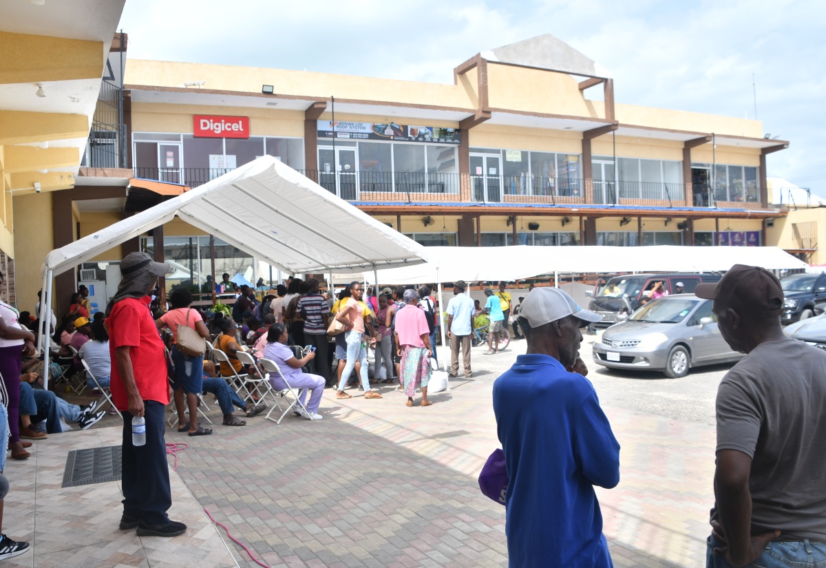 Residents from Black River, St. Elizabeth, and its environs register at the Social Development Commission (SDC) booth, during the agency's Document Recovery Fair, held at the Crawleys Pharmacy parking lot in Black River, on May 29. 
