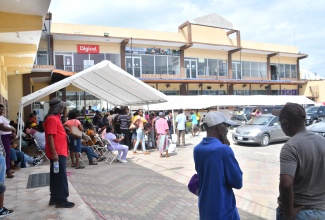 Residents from Black River, St. Elizabeth, and its environs register at the Social Development Commission (SDC) booth, during the agency's Document Recovery Fair, held at the Crawleys Pharmacy parking lot in Black River, on May 29. 
