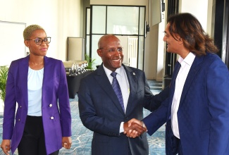 Minister of Industry, Investment and Commerce, Senator the Hon. Aubyn Hill (centre), greets Jamaica Special Economic Zone Authority (JSEZA) Chairman, Ambassador Dushyant Savadia (right), at the launch of the SEZ Facilitation Tool at the AC Marriott Hotel on Thursday (June 11). Sharing in the moment is Chief Executive Officer of JSEZA, Kelli-Dawn Hamilton. The digital platform is designed to enhance the ease of doing business with the country’s Special Economic Zone regime.
