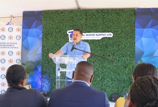 Minister of Water, Environment and Climate Change, Hon. Matthew Samuda, addresses residents during the recent ground-breaking ceremony for a water catchment tank in Stepney, St. Ann,
