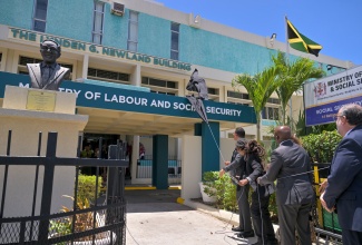 Prime Minister, Dr. the Most Hon. Andrew Holness (left), leads in the recent unveiling of the Ministry of Labour and Social Security's  Lynden G. Newland Building at 14 National Heroes Circle in Kingston, in tribute to the late former Minister of Labour and National Insurance, who spearheaded the passage of the National Insurance Act in 1966. The Prime Minister is joined by Mr. Newland’s grandnephew, Stephen Newland; Portfolio Minister, Hon. Pearnel Charles Jr.; and Leader of the Opposition, Mark Golding.

