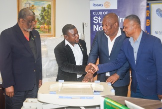 Permanent Secretary in the Ministry of Health and Wellness, Errol Greene (left), looks on as (from second left) Rotary Club of St. Andrew North President, Pierpont Wilson; Southern Regional Health Authority (SRHA) Regional Director, Michael Bent; and SRHA Chairman, Michael Stern, participate in the handover of paediatric medical equipment valued $3 million. The donation, made by the Club to the Black River Hospital in St. Elizabeth, was officially presented to the SRHA during a ceremony held on Friday (June 5) at Jamaica National’s (JN) Corporate Offices in Kingston.