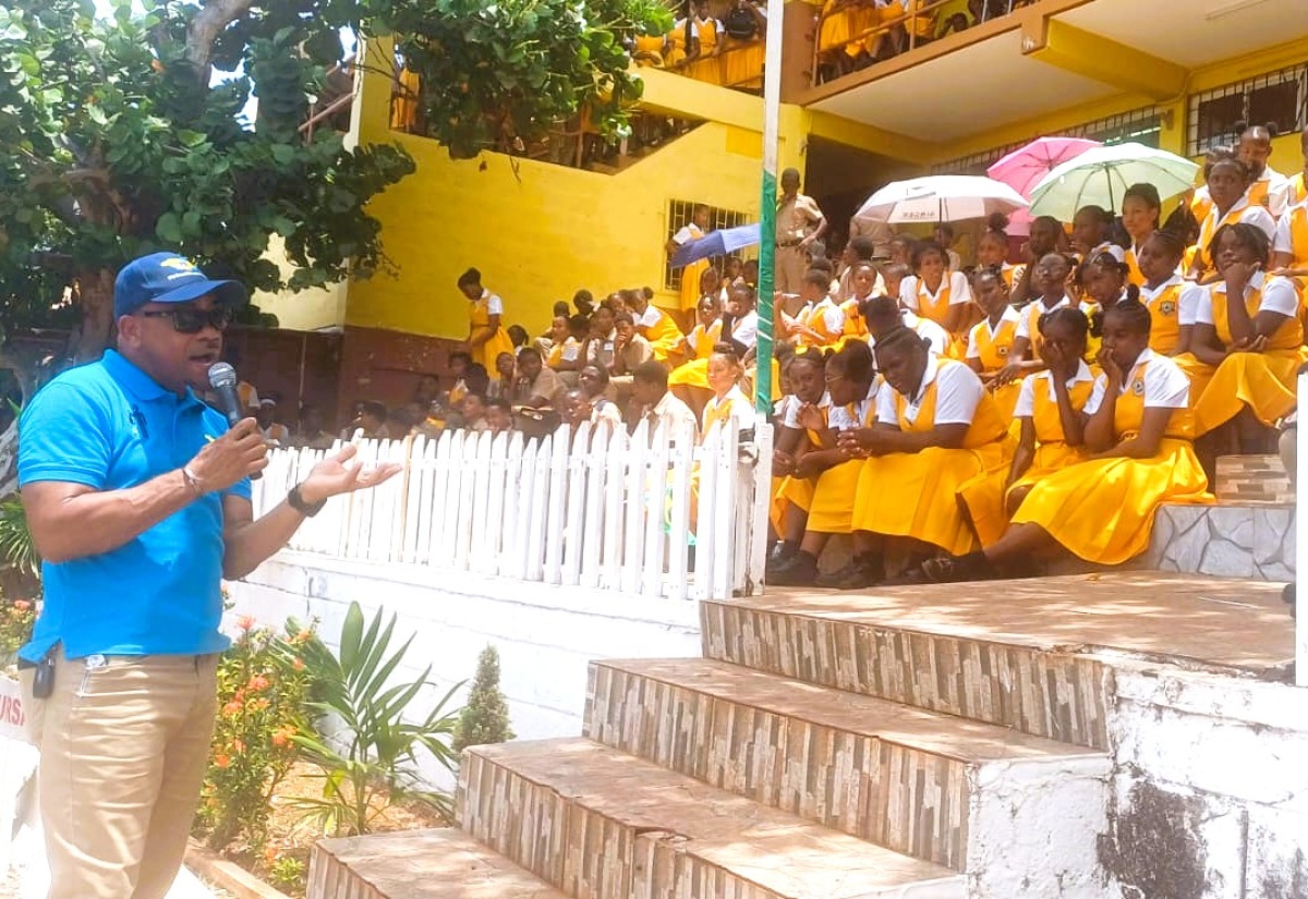 Regional Manager at SPM Waste Management Limited, Sheldon Smith (left), speaks to students at BB Coke High School in Junction, St. Elizabeth, following a recent road show hosted by the agency. 
