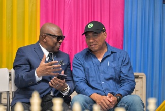 Prime Minister, Dr. the Most Hon. Andrew Holness (right), converses with Jamaica Chess Federation President, Ian Wilkinson, during the St. Andrew West Central Chess Fun Day, hosted at the Olympic Court Community Centre on Saturday (June 6). Dr. Holness serves as Member of Parliament for St. Andrew West Central.