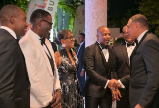 Prime Minister, Dr. the Most Hon. Andrew Holness (right), is greeted by President, Jamaica Chamber of Commerce (JCC), Emile Leiba (third right), on his arrival at the Jamaica Pegasus Hotel in New Kingston on June 11, for the JCC's  41st annual awards banquet. Sharing the moment (from left) are: President and Chief Executive Officer, Jamaica Public Service Company (JPS), Hugh Grant; Vice President and General Manager, Flow Jamaica, Stephen Price; first Vice President, JCC, Martha Miller; and General Manager, Jamaica Pegasus, Brian Sang.