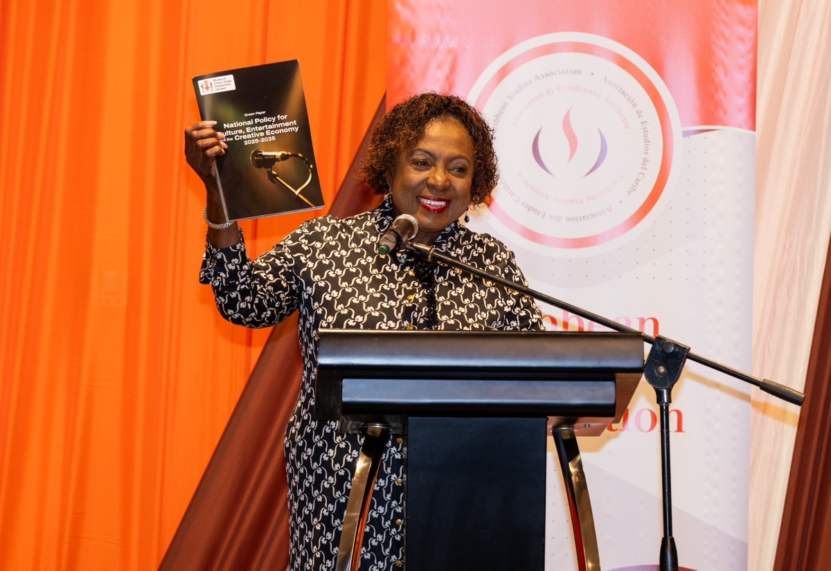 Minister of Culture, Gender, Entertainment and Sport, Hon. Olivia Grange, displays the Green Paper for the National Policy on Culture, Entertainment and the Creative Economy during the 50th  annual conference of the Caribbean Studies Association, held recently at The Jamaica Pegasus hotel in New Kingston.

