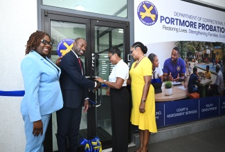 Minister of State in the Ministry of National Security and Peace, Hon. Juliet Cuthbert-Flynn (second right) and Commissioner of Corrections for the Department of Correctional Services (DCS), Brigadier (Retired) Radgh Mason (second left), cut the ribbon for the official opening of the new Portmore Probation Office. The ceremony for the new infrastructure was held on Wednesday (July 8) at the Big Buy Plaza in Portmore, St. Catherine. Sharing in the moment are (from left) Principal Probation Aftercare Officer at the Portmore Probation Office, Kerry-Ann Davis and Permanent Secretary in the Ministry of National Security and Peace, Ambassador Alison Stone Roofe.
