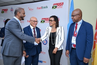 Minister without Portfolio in the Office of the Prime Minister with responsibility for Efficiency, Innovation and Digital Transformation, Ambassador the Hon. Audrey Marks (second right), greets Regional and Capacity-Building Expert,  Universal Postal Union (UPU), Pooran Parampath (left), during the Universal Postal Union (UPU) 2026 to 2029 Operational Readiness for E-Commerce (ORE Plus) kickoff workshop, at the Central Sorting Office, 6-10 South Camp Road, Kingston, on July 21. Sharing the moment (from second left) are Physical Services Implementation and Capacity-Building Programme Manager, Universal Postal Union (UPU), Chokri Ellili, and Postmaster General, Post and Telecommunications Department, Lincoln Allen.
