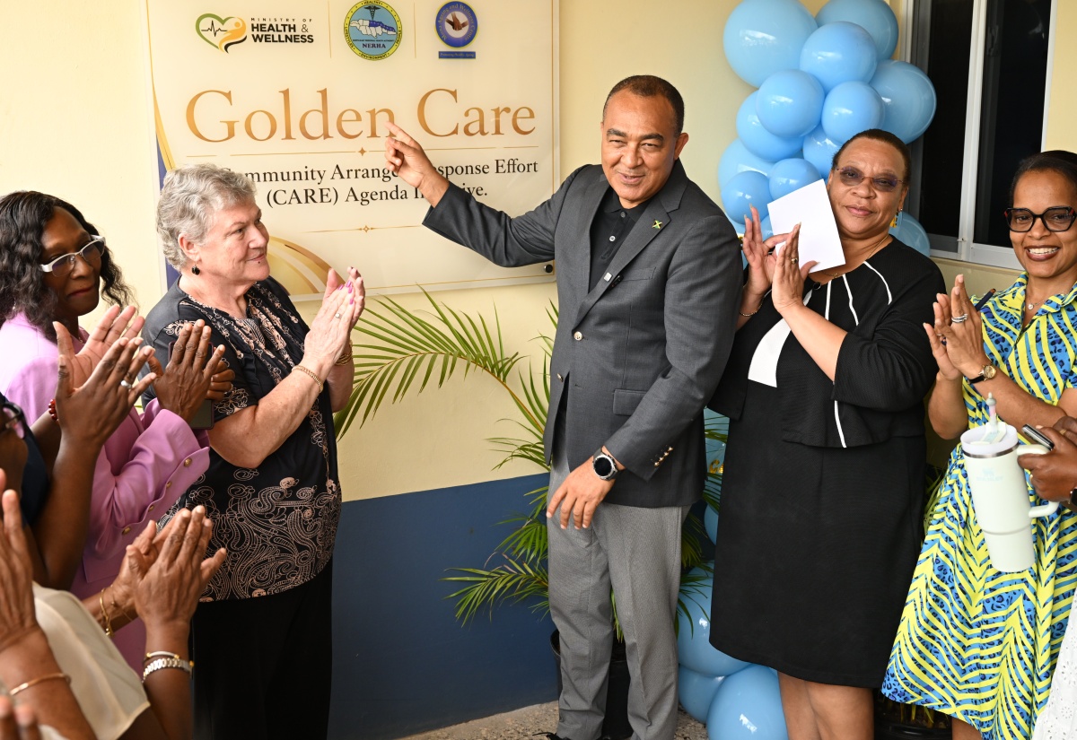 Health and Wellness Minister,  Dr. the Hon. Christopher Tufton (third right), unveils the Golden CARE sign during the official launch, at the Claremont Centre of Excellence (Health Centre) in St. Ann, on July 22. He is joined by (from left) Dr. Carol Lord; Executive Director of Mona Ageing and Wellness Centre, Professor, the Most Hon. Denise Eldemire Shearer; Regional Director of North East Regional Health Authority (NERHA), Fabia Lamm; and Parish Manager of the St. Ann Health Department, Nadia Nunes-Hyde.
