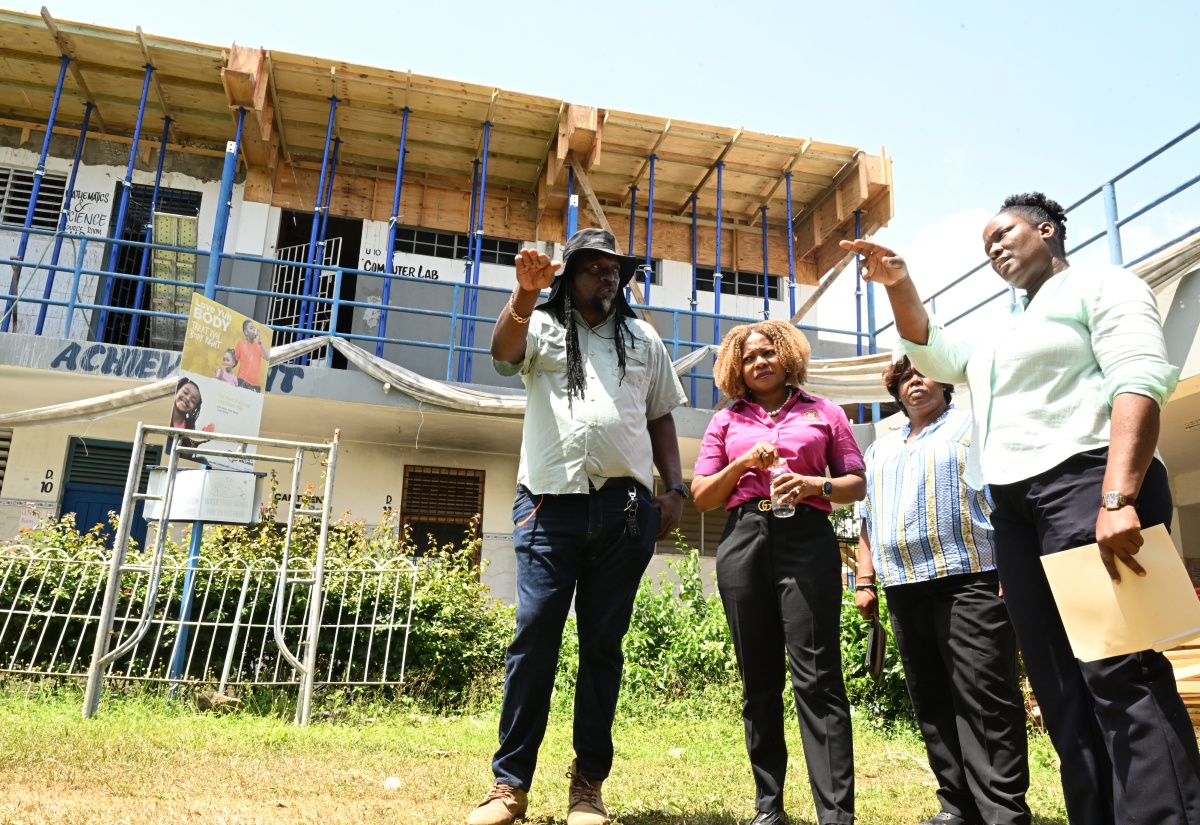 Minister of Education, Skills, Youth and Information, Senator Dr. the Hon. Dana Morris Dixon (second left), listens as Principal of Unity Primary School, Dawnett Hall-Beharie (right), provides an update on ongoing repair and reconstruction works at the institution during the Minister's Back-to-School Readiness Tour in Westmoreland on Tuesday, July 28. Looking on are (from left) Building Officer in the Ministry of Education, Skills, Youth and Information, Deran Lee, and Regional Director of the Ministry of Education, Skills, Youth and Information’s Region Four, Dr. Michelle Pinnock.
