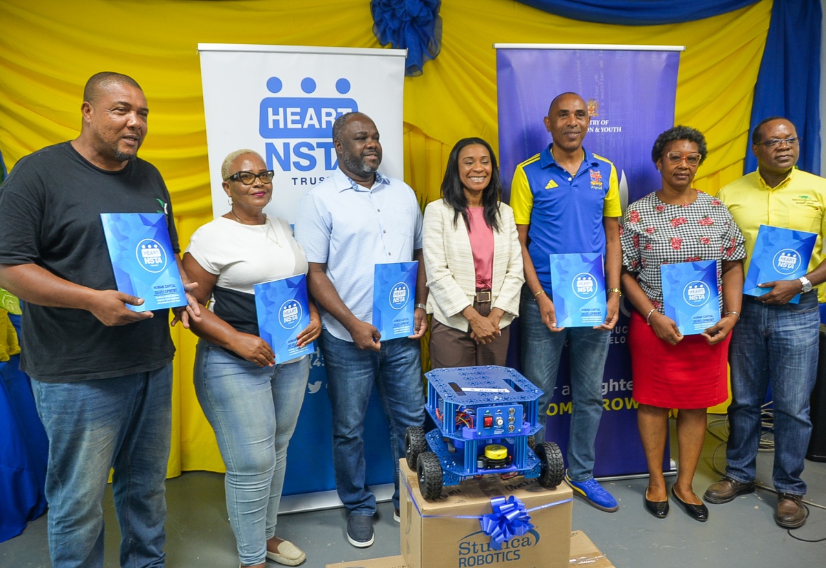 Managing Director of the HEART/NSTA Trust, Dr. Taneisha Ingleton (centre), shares a moment with principals and teachers from six technical high schools who were presented with robotics kits at the HEART College of Construction in Portmore, St. Catherine, on Tuesday (July 28). From left are principal, Knockalva Technical High School, Gregory Brown; teacher, Frome Technical High School, Paulette Kerr; principal, St. Mary Technical High School, Orville Richards; principal, St. Elizabeth Technical High School, Keith Wellington; acting vice principal, Herbert Morrison Technical High School, Shawnette Dewar; and principal, Dunoon Park Technical High School, Shawn Aarons.
