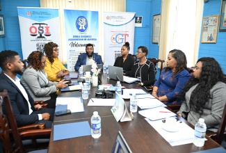 Supervisor of Insolvency, Fayola Evans Roberts (third right), and other stakeholders listen to remarks being delivered by Small Business Association of Jamaica (SBAJ) President, Garnett Reid (centre), during a hybrid webinar for micro, small and medium-sized Enterprises (MSMEs). The session, organised by the Office of the Supervisor of Insolvency (OSI) and the Office of the Government Trustee (OGT), was hosted at the SBAJ in Kingston on Monday (June 29). Among the other participants are SBAJ Second Vice President, Dennise Williams (third left), and Deputy Government Trustee, Gabrielle Munoz (fourth right).
