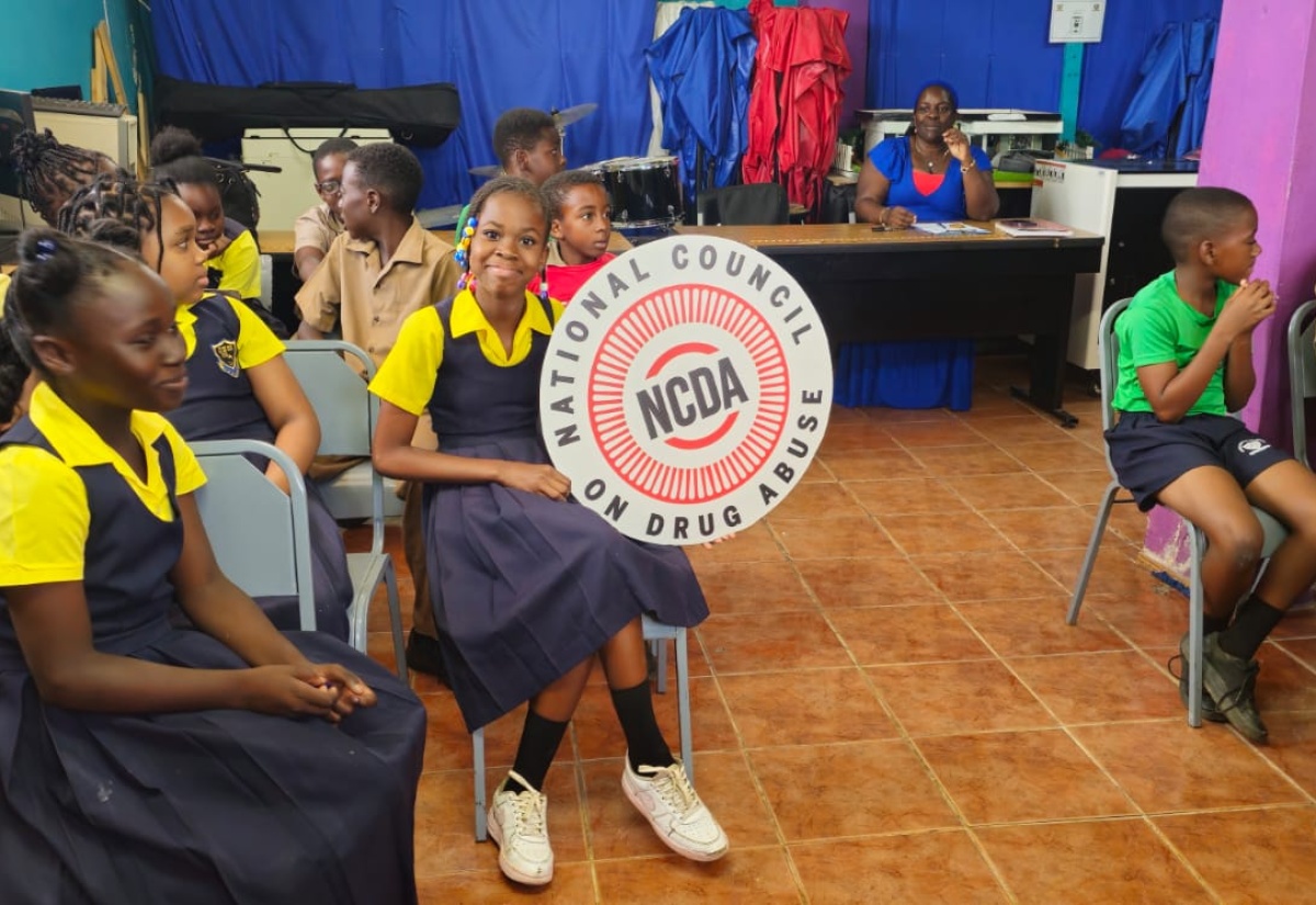 A student proudly displays a National Council on Drug Abuse (NCDA) awareness sign, during an educational session at Golden Grove All-Age School in St. Ann on June 25.
