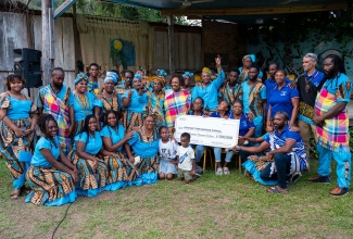 Minister of Culture, Gender, Entertainment and Sport, Hon. Olivia Grange (centre, middle row), poses for a photograph with members of the Charles Town Maroon Council and community following the presentation of a $500,000 cheque from the Ministry in support of the 18th Annual International Charles Town Maroon Conference and Festival, held recently under the theme ‘Resilience: Yesterday, Today and Tomorrow’.

