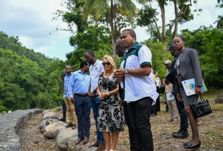 Minister of Agriculture, Fisheries and Mining, Hon. Floyd Green (second right), and Head of Delegation of the European Union to Jamaica, Belize and The Bahamas, Ambassador Dr. Erja Askola (third right), tour the renovation works at the Castleton Botanical Gardens in St. Mary, including boulder packing along the northeastern embankment adjacent to the Wag Water River. Accompanying them are (from left) Chief Technical Director for Special Projects in the Ministry of Agriculture, Fisheries and Mining, Courtney Cole; Superintendent of the Public Gardens and Zoo Branch, Michael Williams; and Director of Estate Management and Business Development at the Jamaica National Heritage Trust, Brendalyn Henry. The $170‑million project was carried out under the multi‑year 
