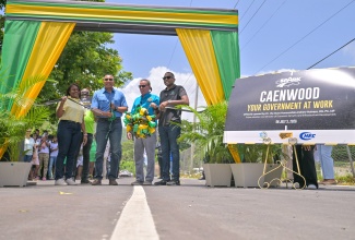 Prime Minister, Dr. the Most Hon. Andrew Holness (second left) cuts the ribbon to officially open the Caenwood Road in Portland on Friday (July 3), under the Government