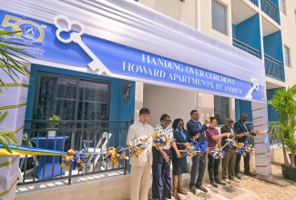 Prime Minister, Dr. the Most Hon. Andrew Holness cuts the ribbon to officially open the 248 studio apartments in the Howard Avenue Housing Development, 10-16 Howard Avenue, St. Andrew on July 29. He is joined by (from left) Managing Director, Centauri Real Estate Company Limited, Julian Zhu; Member of Parliament, St. Andrew South Western, Dr. Angela Brown Burke; beneficiary, Deon Thomas; Ambassador, People’s Republic of China to Jamaica, His Excellency Wang Jinfeng; Chairman, National Housing Trust (NHT), Linval Freeman; and Managing Director, NHT, Martin Miller.
