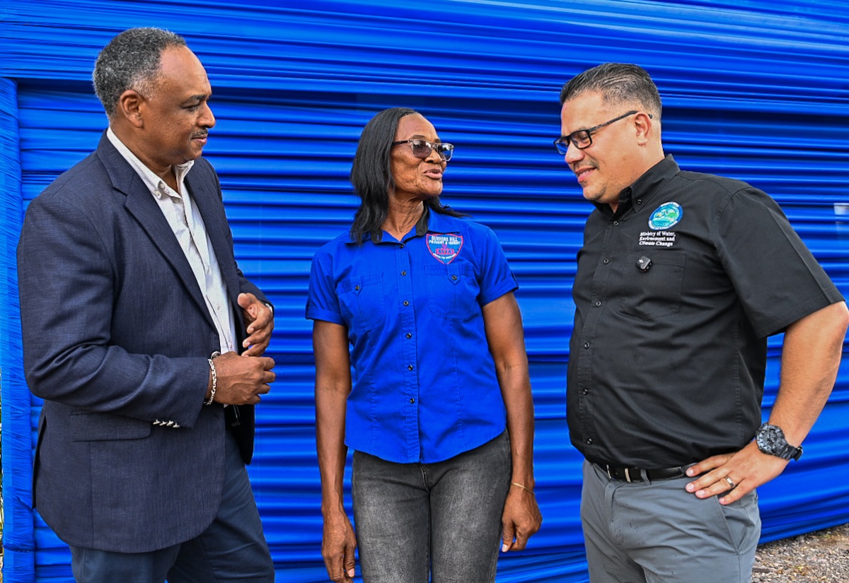 Minister of Water, Environment and Climate Change, Hon. Matthew Samuda (right), in conversation with Principal of the Bunkers Hill Primary and Infant School in Clarendon, Nathalia Lewis (centre), while Chairman of the Rural Water Supply Limited, Omar Sweeney, looks on, during the official commissioning of the Bunkers Hill Water Supply System in the parish, on August 25.

