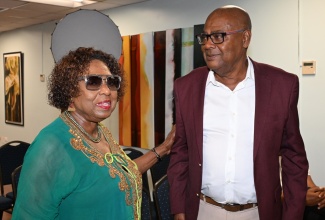 Minister of Culture, Gender, Entertainment and Sport, Hon. Olivia Grange (left), in discussion with President of the Jamaica Football Federation (JFF), Michael Ricketts, during the signing of the Guarantee Agreement for the co-hosting of the 2031 FIFA Senior Women’s World Cup, at the Ministry’s Offices in Kingston, on August 11.

