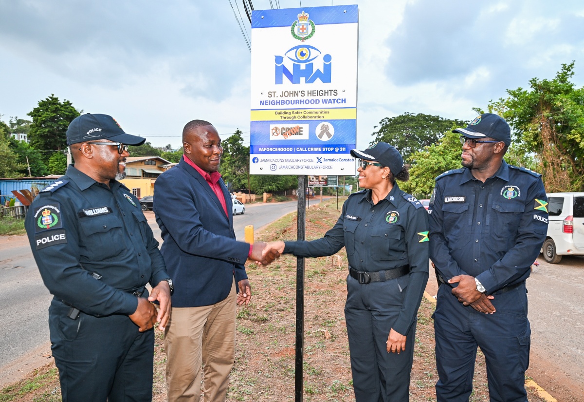 President of the St. John’s Heights Citizens Association in St. Catherine, Yian Shettlewood (second left), greets Head of the Jamaica Constabulary Force (JCF) Community Safety and Security Branch, Assistant Commissioner of Police (ACP) Charmaine Shand, during the launch of the St. John’s Heights Neighbourhood Watch in St. Catherine on Sunday (August 23). Looking on (from left) are Territorial Officer in the St. Catherine North Police Division, Inspector Ishmael Williams, and Commanding Officer, Senior Superintendent of Police (SSP) Hopton Nicholson.

