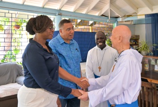 Prime Minister, Dr. the Most Hon. Andrew Holness (second left), and Speaker of the House of Representatives, the Most Hon. Juliet Holness, are greeted by Founder of the Missionaries of the Poor, Father Richard Ho Lung (right), during a visit to the religious order's Hanover Street facility in downtown Kingston on Wednesday (August 19). Looking on is Missionaries of the Poor Mission Superior for Jamaica, Brother Anthony Wechuli. The visit formed part of consultations aimed at improving the Missionaries of the Poor Holy Innocents Convent under the Urban Development Corporation’s (UDC) broader Central Kingston development plan.
