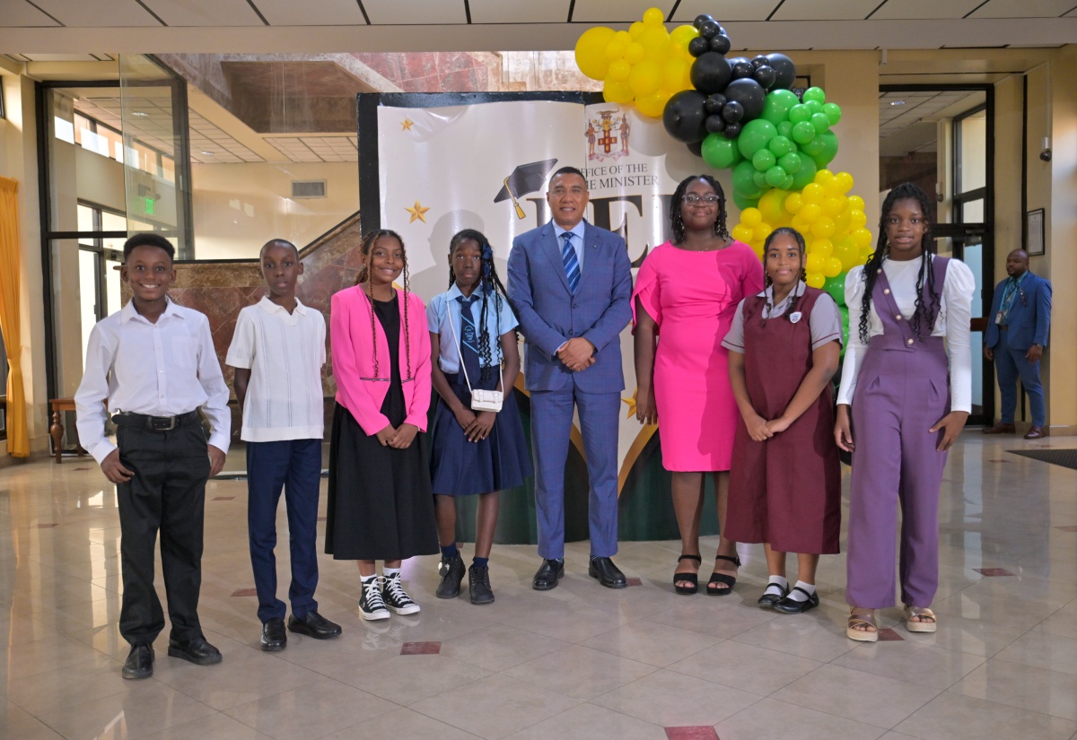 Prime Minister, Dr. the Most Hon. Andrew Holness (fifth left), shares lens with awardees during the annual Primary Exit Profile (PEP) awards function for children of employees at the Office of the Prime Minister (OPM) and the Office of the Cabinet (OC), on Thursday (August 13) at Executive Lobby, OPM. They are (from left) Zachary Kentish, Aaron Hamilton, Jade Stewart, Kamoya McCalla, Hannah Blake, Dejaea Wright and Amilia Davis. Two awardees, Robyn Samuels and James Seaton, were unavoidably absent. 
