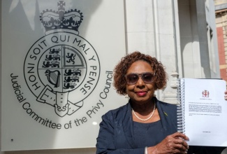Minister of Culture, Gender, Entertainment and Sport, Hon Olivia Grange, stands in front of the Judicial Committee of the Privy Council building in London, England, holding the historic reparations petition document filed to His Majesty King Charles III on Monday (September 7).