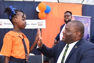 Parliamentary Secretary in the Ministry of Education, Skills, Youth and Information, Senator Marlon Morgan, gives a 'high five' to student of Edward Seaga Primary School in Kingston, Ajonieke Whittingham, during a visit to the institution on the first day of the 2026/27 academic year on Monday (September 7).
