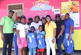 Executive Assistant, Tank Weld Metals, Judith Forrester (fifth right), shares a moment with Principal of the Rio Bueno Primary and Infant School, Shawni Wilson Cunningham (fourth right),  staff, students and parents, during a back-to-school event at the institution in Trelawny on Tuesday (Sept. 1).
