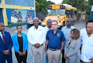 Minister of Energy, Transport and Telecommunications, Hon. Daryl Vaz (third right, front row), and Minister of Education, Skills, Youth and Information, Senator Dr. the Hon. Dana Morris Dixon (second right, front row), join officials and representatives for a photo at Yallahs Primary School in St. Thomas during the rollout of the Rural School Bus Programme Back-to-School Tour on Monday (September 7). Also pictured (from left, front row) are Managing Director of the Transport Authority, Ralston Smith; General Manager of the National Rural School Bus Service, Anita Rambally; Managing Director of the Jamaica Urban Transit Company (JUTC), Owen Ellington; and Member of Parliament for St. Thomas Western, James Robertson. Standing at back (from left) are St. Thomas Municipal Corporation Councillors John Lee, Dean Jones and Andrea Patience.
