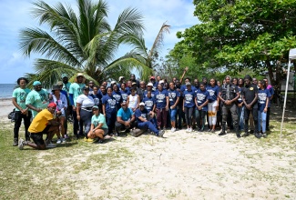 A large group of volunteers participate in a clean-up of the Rocky Point Beach in St. Thomas on September 19.
