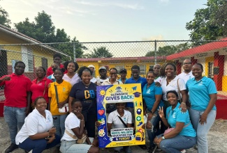 Founder of the NIA Foundation and 2026 Governor-General’s Achievement Award recipient, Sasha Williams (centre), poses for a photograph with volunteers during the ‘Glengoffe Gives Back: Community Health, Mental Wellness, Education Fair and Fun Day’, held at Grateful Hill Primary and Infant School in Glengoffe, St. Catherine, on August 22.

