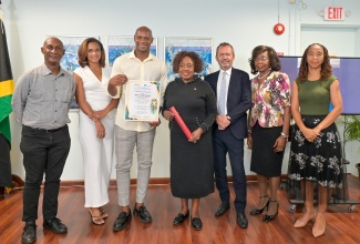 Minister of Culture, Gender, Entertainment and Sport, Hon. Olivia Grange (centre), joins Jamaican sprint legend Asafa Powell (third left), in honouring retired Physical Education Teacher at Charlemont High School, Elaine Fraser, who helped shaped Mr. Powell's athletic development.  Sharing the moment are Principal of Charlemont High School and President of the Jamaica Athletics Administrative Association (JAAA), Garth Gayle; Mr. Powell's wife, Alyshia Miller-Powell; Regional Director and Representative of the United Nations Educational, Scientific and Cultural Organization (UNESCO) Cluster Office of the Caribbean, Eric Falt; Chief Executive Officer of the Jamaica Teaching Council (JTC), Dr. Winsome Gordon; and Programme Manager, Jamaica National Commission for UNESCO, Roberta Ellis. Occasion was the recent World Teachers' Day 2026 Commemoration under the theme 'Teachers Inspiring Champions: The Role of Educators in Sporting Excellence and National Development' at the Ministry’s offices in New Kingston. Mr. Powell delivered the main address on the topic 'The Teachers Who Believed in Me.'

