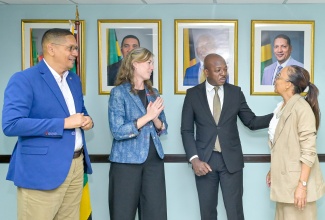 Minister of Labour and Social Security, Hon. Pearnel Charles Jr. (second right), and State Minister, Hon. Donovan Williams (left), engage in discussion with executives from Red Stripe, during a courtesy call at the Ministry’s North Street offices in Kingston, on Thursday (October 15). The executives are (from second left) Managing Director, Holly Bostock; and Head of Corporate Affairs, Dianne Ashton-Smith.