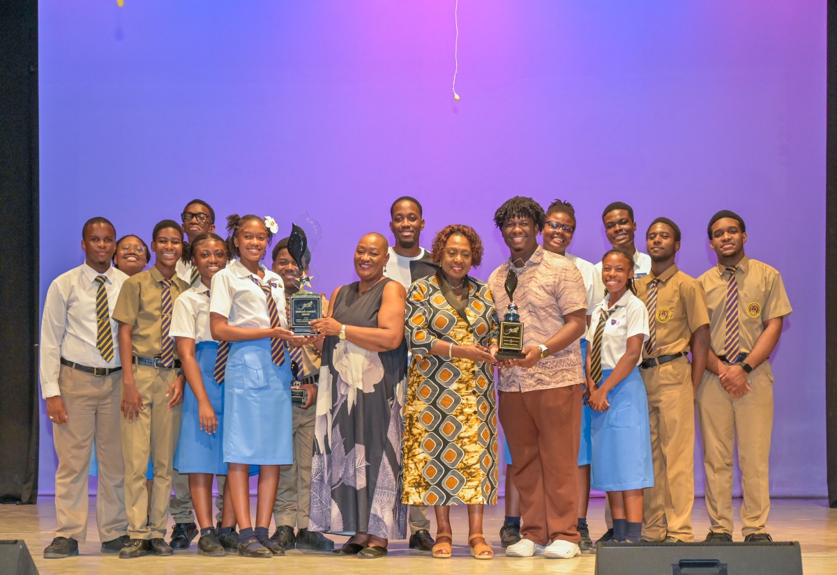 Minister of Culture, Gender, Entertainment and Sport, the Hon. Olivia Grange (fifth right, front row), presents members of the Ardenne High School performing arts groups with the Jamaica Cultural Development Commission (JCDC) Marcus Garvey Award for Excellence in the Performing Arts. Ardenne High School received the award during the presentation ceremony held at the Little Theatre in Kingston on Thursday (October 15). Sharing the moment is the school