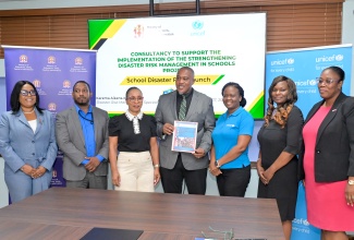 National Coordinator of the Schools Safety Branch in the Ministry of Education, Skills, Youth and Information, Richard Troupe (centre), and Consultant, Karema Aikens-Mitchell (third left), pose for a photo opportunity with stakeholders during the launch of the Strengthening Disaster Risk Management in Schools Project on Tuesday (October 27) at the Ministry’s offices in Kingston.
