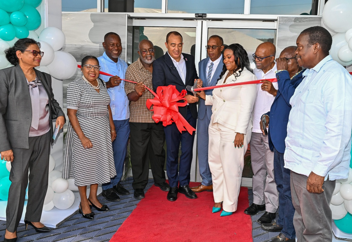 Minister of Health and Wellness, Dr. the Hon. Christopher Tufton (fifth left), cuts the ribbon to officially open the Tensie Mae Robinson (TMR) Medical Limited in Portmore, St. Catherine, on Wednesday (October 7). He is joined by (from left) Chief Medical Officer (CMO) of Jamaica, Dr. Jacquiline Bisasor-McKenzie; Custos of St. Catherine, Hon. Icylin Golding; Mayor of Portmore, Councillor Leon Thomas; Member of Parliament for South St. Catherine, Fitz Jackson; TMR Medical Limited Board Chairman, Dwight Robinson; Chief Executive Officer of TMR Medical Limited, Deidre Ann Dennis; Medical Director at TMR Medical Limited, Dr. Morais Guy, Managing Director of Dwight’s Construction, Benton Woodbine; and Minister without Portfolio in the Ministry of Economic Growth and Infrastructure Development with responsibility for Land Titling and Settlements, Hon. Robert Montague.
