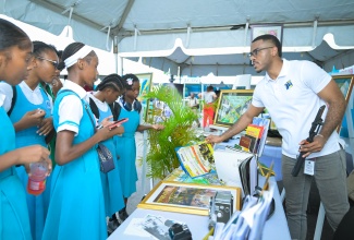 Students of Lacovia High School visit the Jamaica Information Service (JIS) exhibition booth during a Visual Arts Symposium hosted by the school in partnership with Studio Mortimer Limited. Special Projects Manager, Paul Allen, shared information on the agency’s 2026 Heritage Competition and highlighted opportunities for young creatives to showcase their talents.

