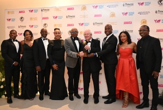 Minister of Tourism, Hon. Edmund Bartlett (fifth left); President and Founder of the World Travel Awards, Graham Cooke (sixth left), and Chief Executive Officer of MBJ Airports, operators of Sangster International Airport (SIA) in St. James, Shane Munroe (third right), share a moment with the SIA team. Occasion was the World Travel Awards Caribbean and the Americas Gala, held at Princess Grand Jamaica in Hanover on Sunday (October 11). SIA copped the Caribbean’s Leading Airport for 2026. 
