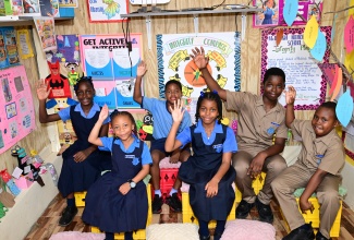 Students at McIntosh Memorial Primary School in Manchester proudly demonstrate their commitment to the values promoted through the institution's Integrity Corner initiative.

